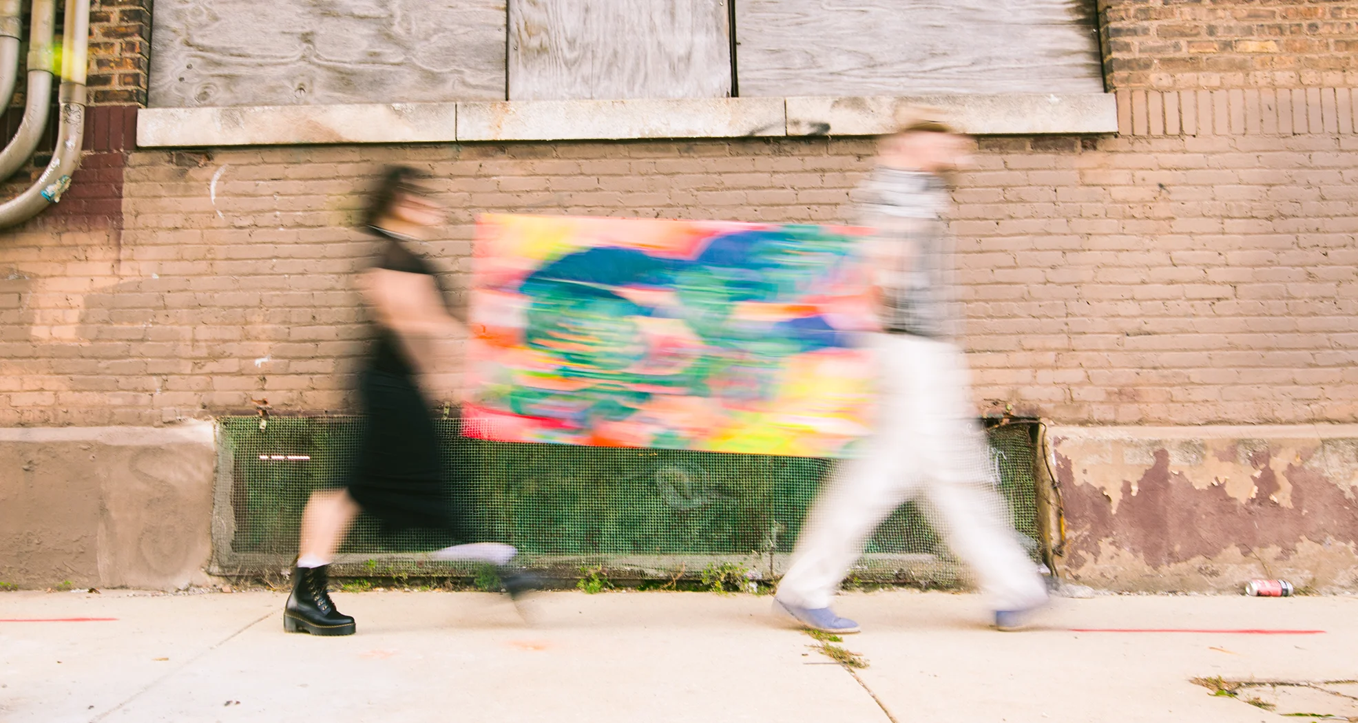 Reid and Claudia carrying a tropical painting through Chicago