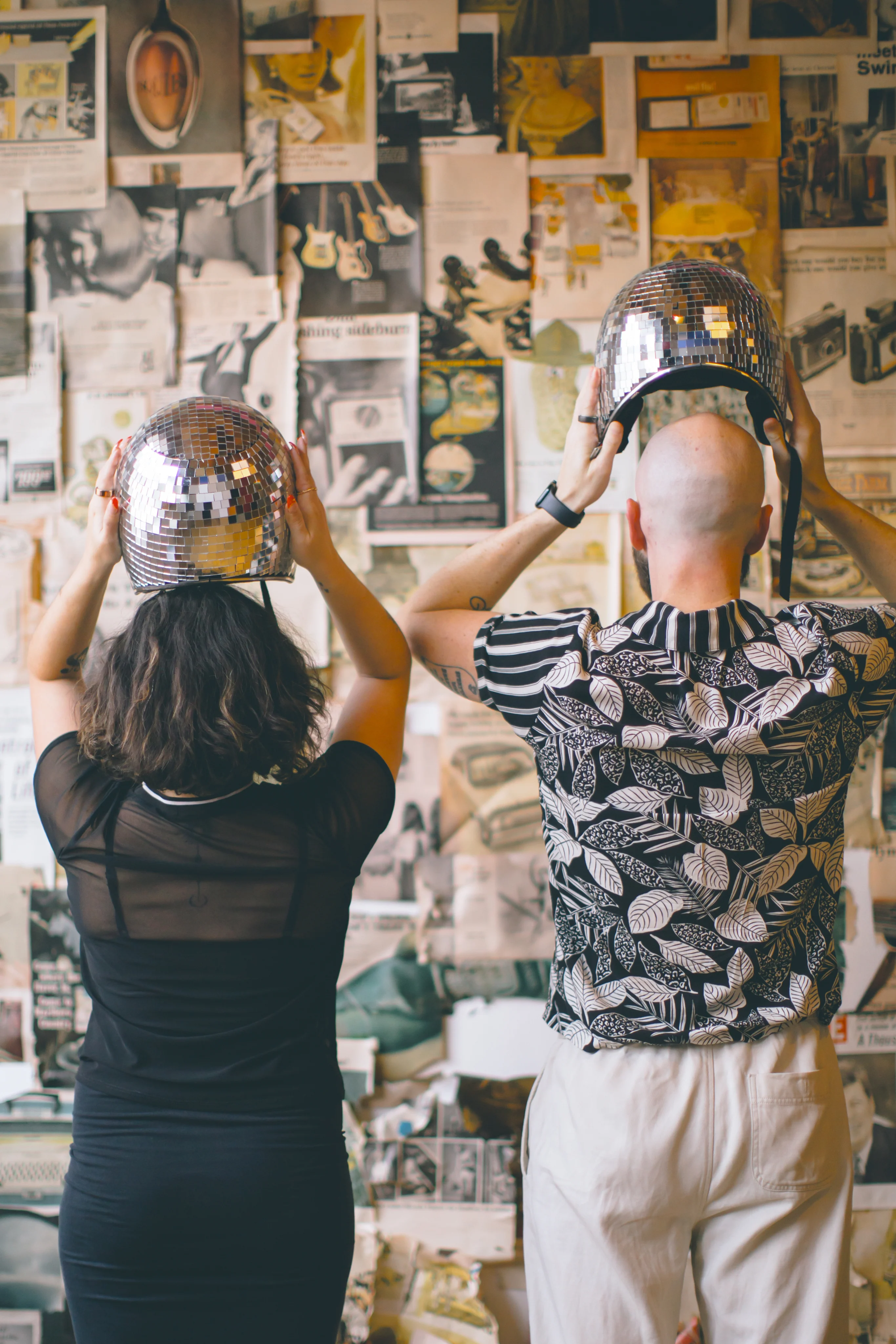 Claudia and Reid wearing disco helmets.